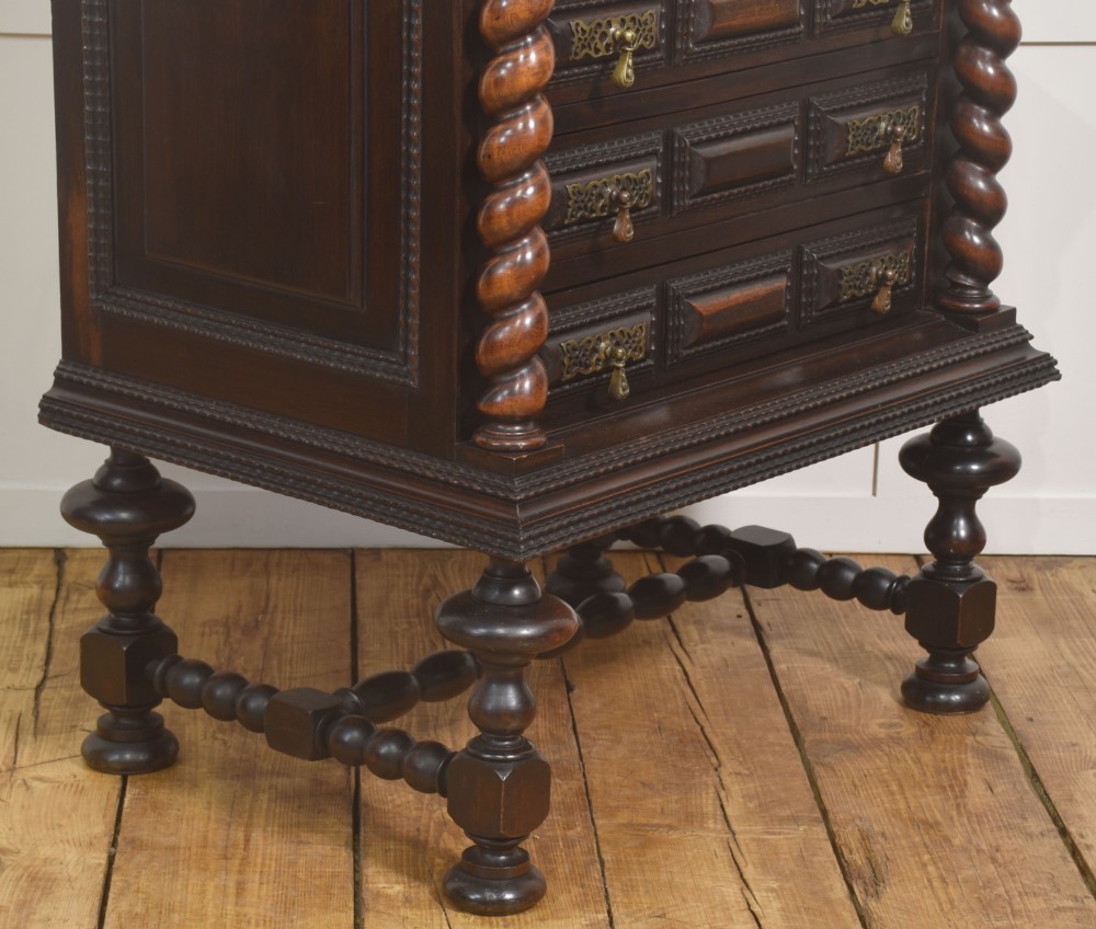 A 19th-century dark rosewood chest on stand with four drawers, pierced brass drop handles, barley twist side columns, and turned legs. View V