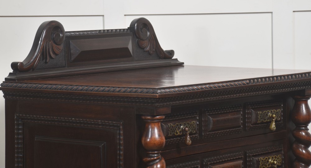 A 19th-century dark rosewood chest on stand with four drawers, pierced brass drop handles, barley twist side columns, and turned legs. View VI