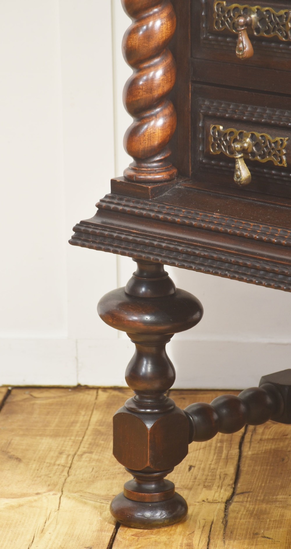 A 19th-century dark rosewood chest on stand with four drawers, pierced brass drop handles, barley twist side columns, and turned legs. View IX