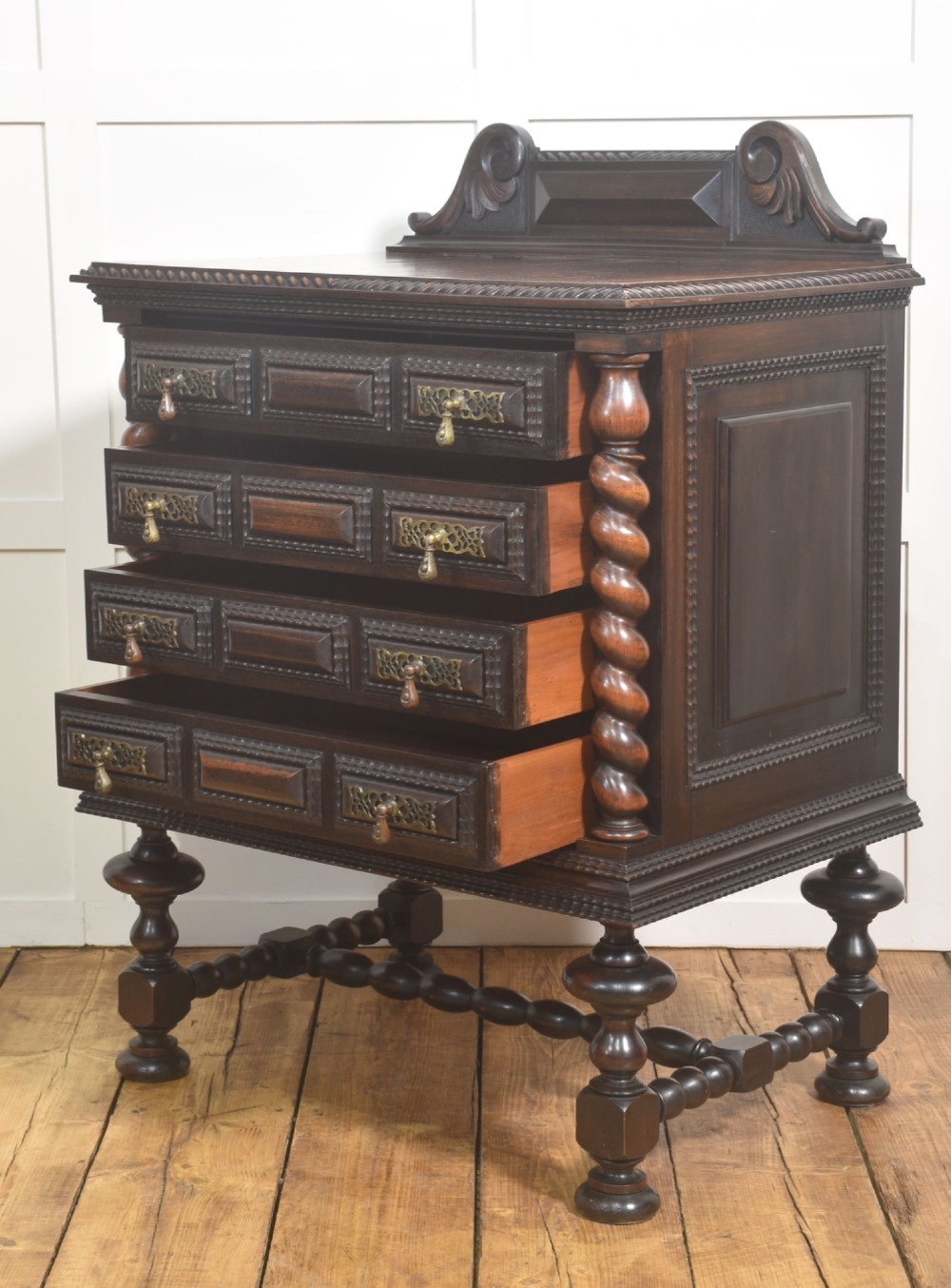 A 19th-century dark rosewood chest on stand with four drawers, pierced brass drop handles, barley twist side columns, and turned legs. View X