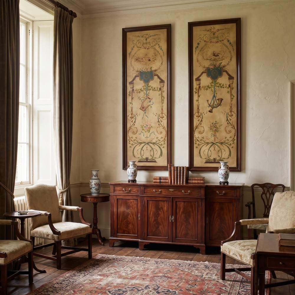A pair of tall rectangular dark wood framed panels featuring hand-painted Neoclassical motifs, lyres, floral swags, and Napoleonic heraldry on a gold ground. View II