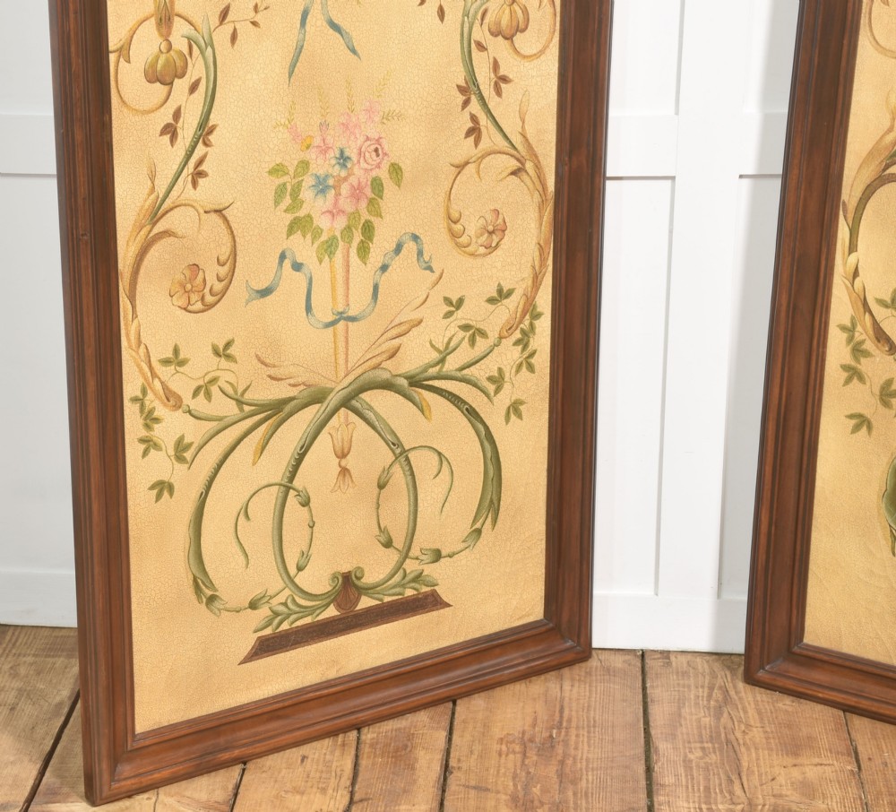 A pair of tall rectangular dark wood framed panels featuring hand-painted Neoclassical motifs, lyres, floral swags, and Napoleonic heraldry on a gold ground. View V