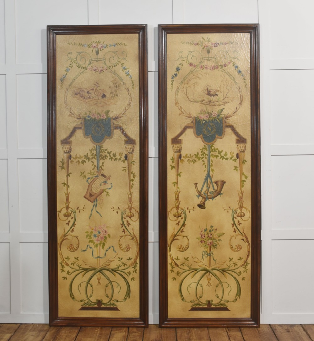 A pair of tall rectangular dark wood framed panels featuring hand-painted Neoclassical motifs, lyres, floral swags, and Napoleonic heraldry on a gold ground. View VIII