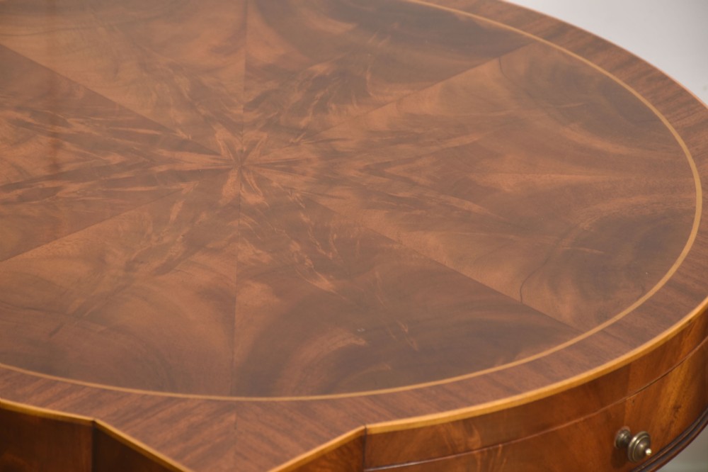 A pair of mahogany Sheraton Revival side tables featuring shaped inlaid tops, single frieze drawers, fluted tapered legs, and brass castors. View XII