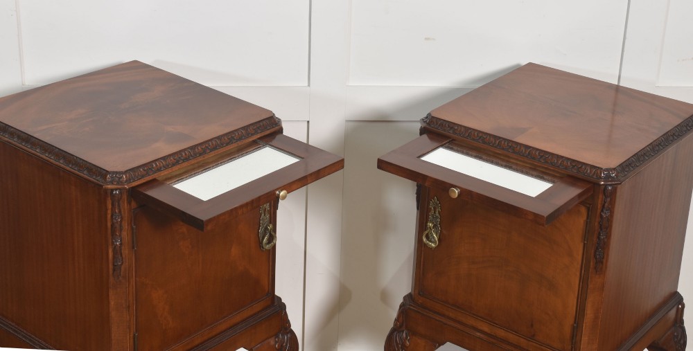 A pair of warm brown mahogany Chippendale style bedside cabinets featuring carved cabriole legs ending in ball and claw feet, flame mahogany single door cupboards, brass drop handles, and pull-out brush slides. View XI