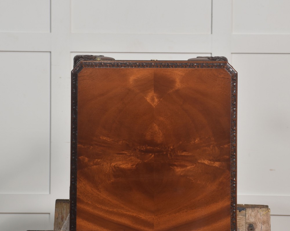 A pair of warm brown mahogany Chippendale style bedside cabinets featuring carved cabriole legs ending in ball and claw feet, flame mahogany single door cupboards, brass drop handles, and pull-out brush slides. View XIV
