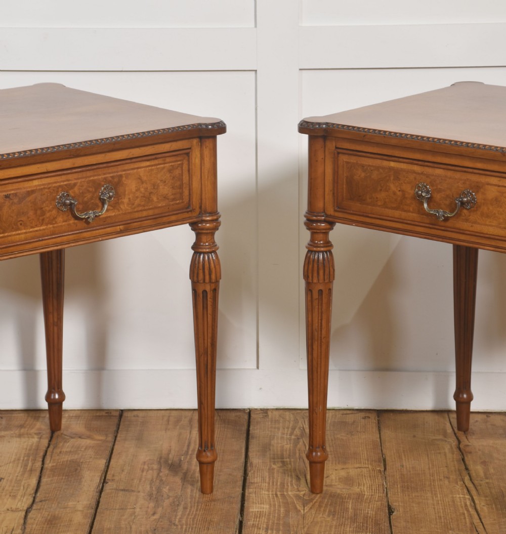 A pair of Edwardian walnut side tables featuring single drawers with brass handles and fluted turned legs. View VIII