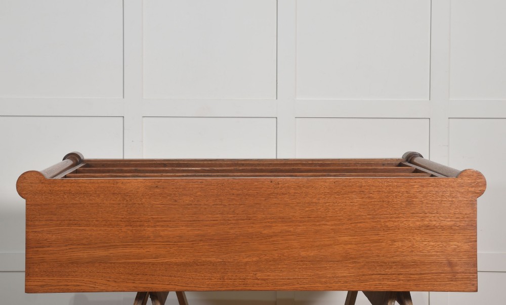 A late nineteenth-century warm brown oak open bookcase featuring three horizontal shelves flanked by fluted side pilasters on a plinth base. View XIV