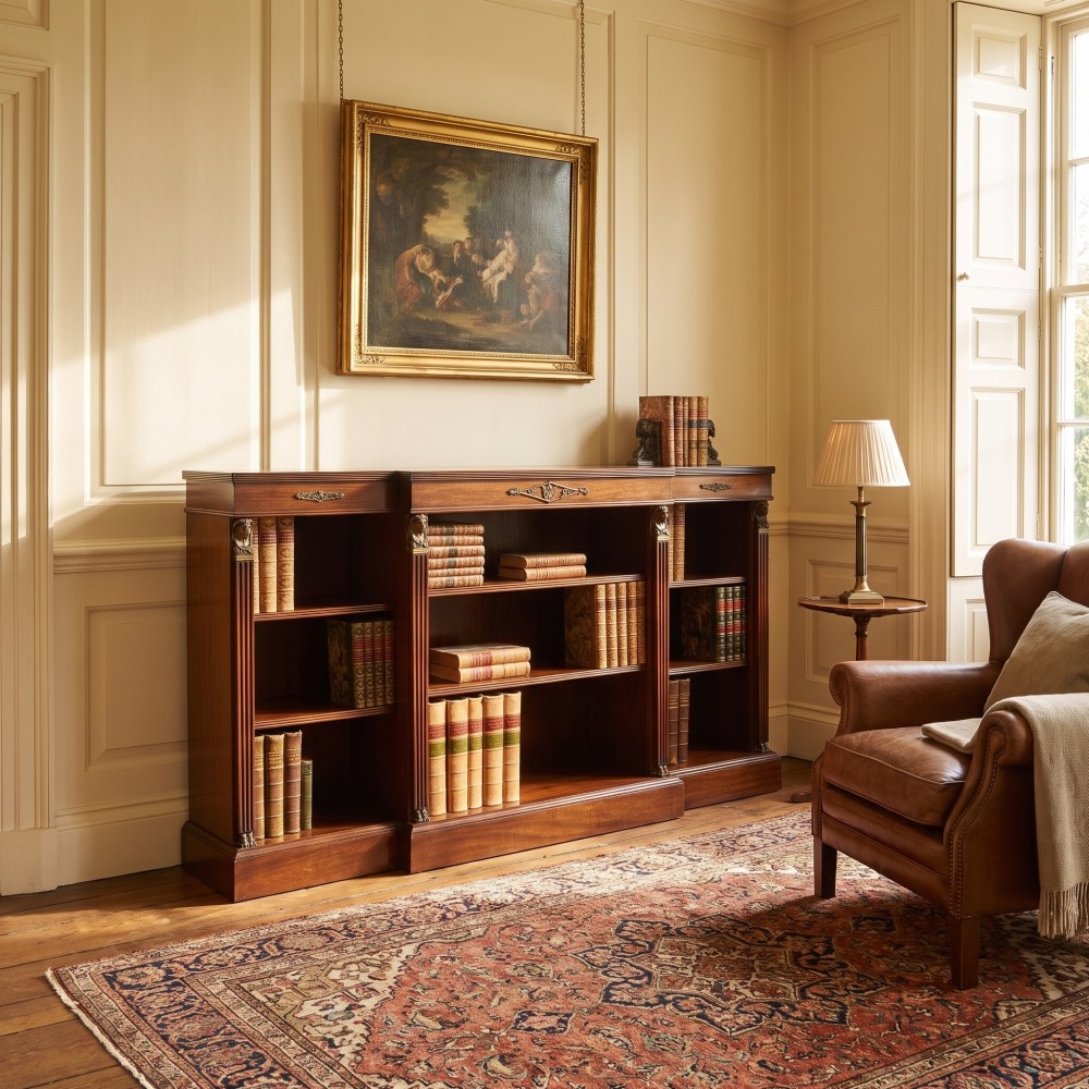 A low Regency style mahogany breakfront open bookcase featuring fluted pilasters, brass mounts, and adjustable shelves. View II