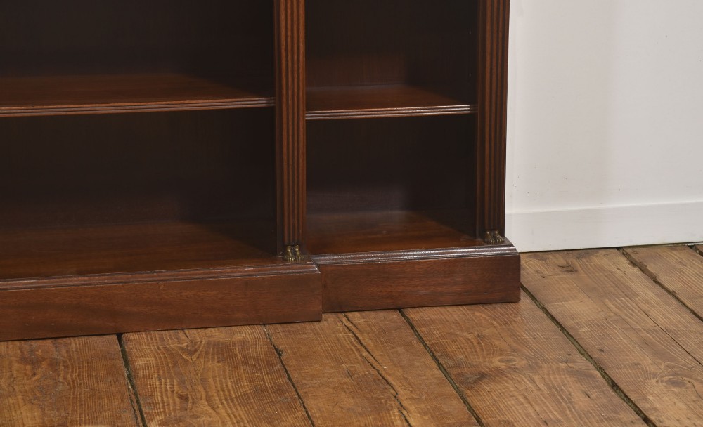 A low Regency style mahogany breakfront open bookcase featuring fluted pilasters, brass mounts, and adjustable shelves. View III
