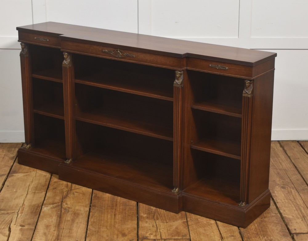 A low Regency style mahogany breakfront open bookcase featuring fluted pilasters, brass mounts, and adjustable shelves. View IV