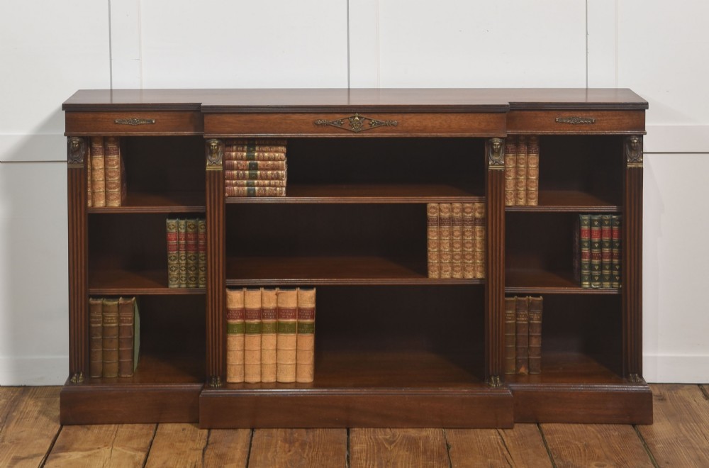 A low Regency style mahogany breakfront open bookcase featuring fluted pilasters, brass mounts, and adjustable shelves. View V