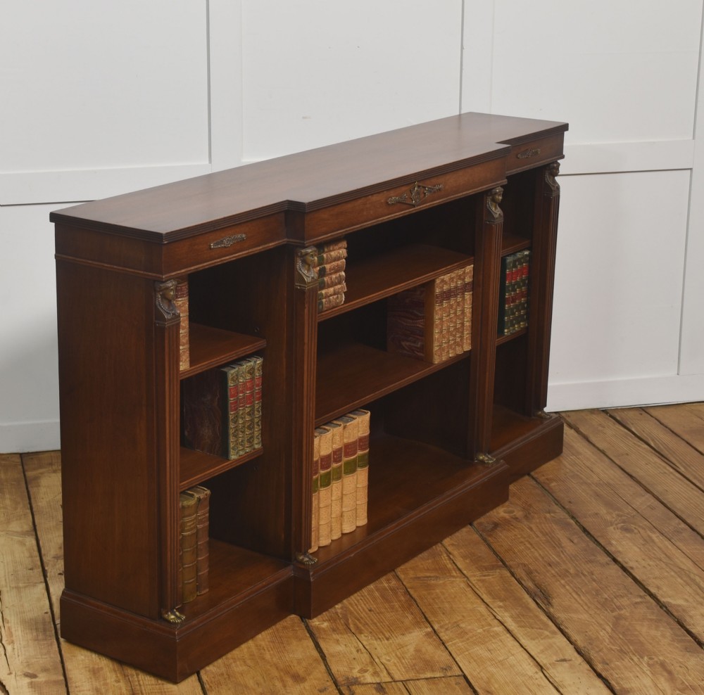 A low Regency style mahogany breakfront open bookcase featuring fluted pilasters, brass mounts, and adjustable shelves. View VII