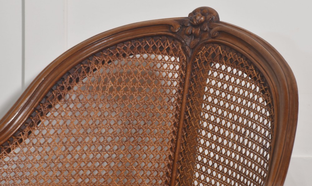 A 19th-century French Louis XV style carved walnut corner tub chair with a woven cane backrest and curved cabriole legs. View VIII