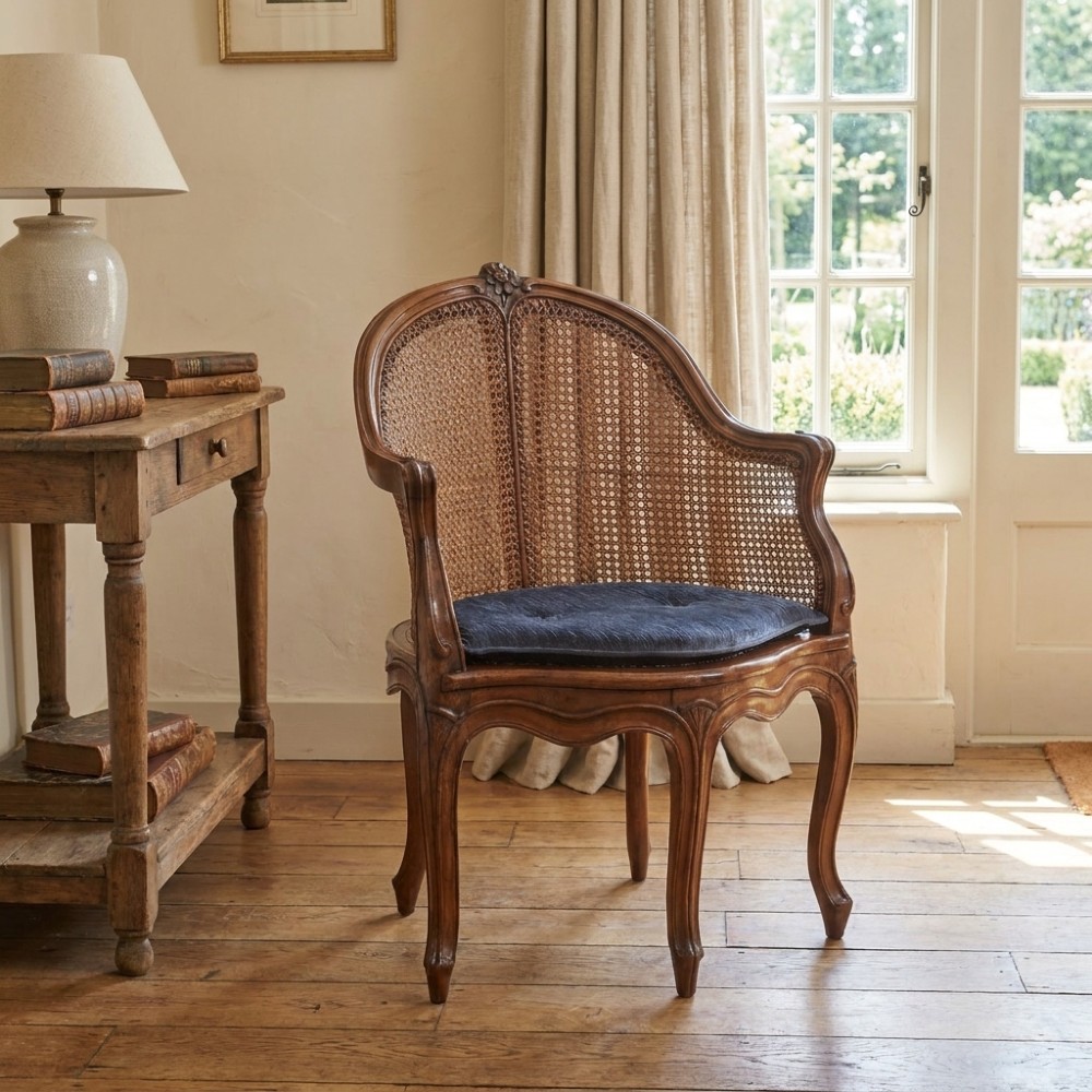 A 19th-century French Louis XV style carved walnut corner tub chair with a woven cane backrest and curved cabriole legs. View X
