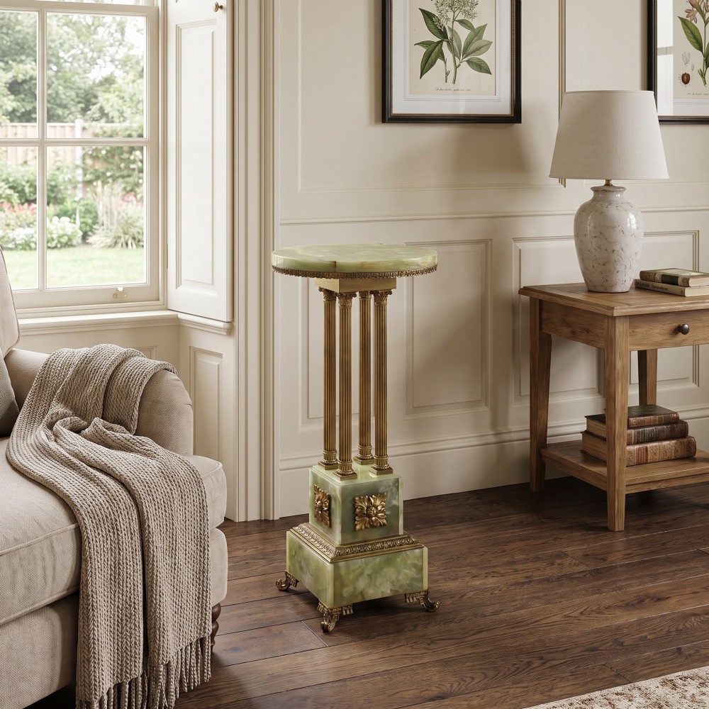 A Neoclassical circular green onyx pedestal table supported by four fluted gilt brass columns on a stepped plinth base. View II