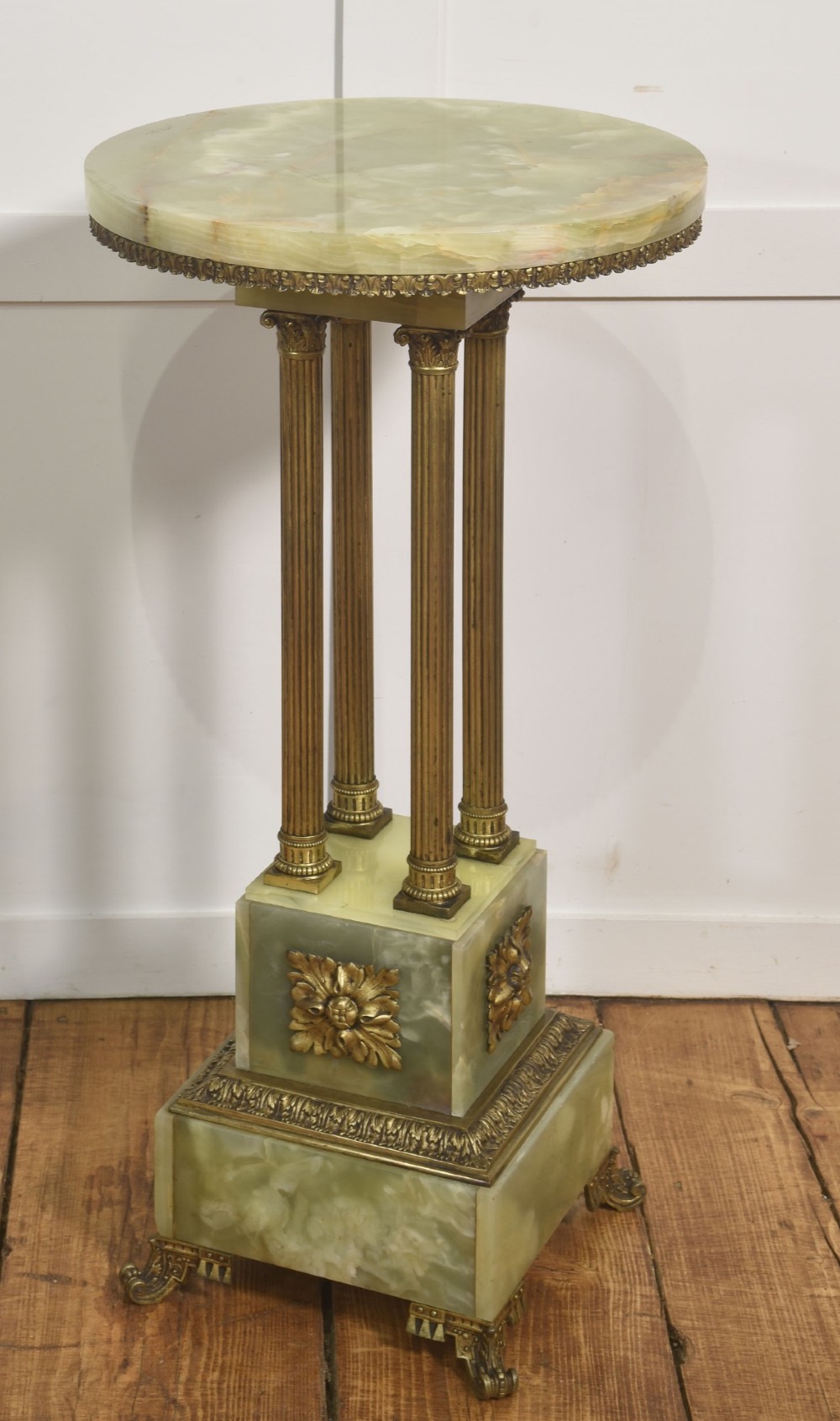 A Neoclassical circular green onyx pedestal table supported by four fluted gilt brass columns on a stepped plinth base. View III