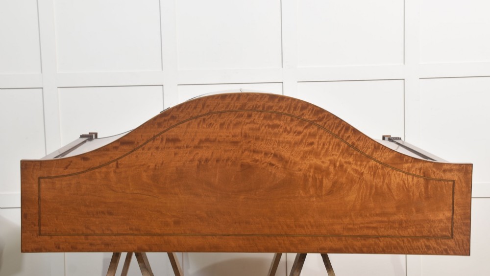 A Sheraton Revival bow-front wooden sideboard featuring oval inlaid veneer door panels, top drawers, and square tapered legs. View XII