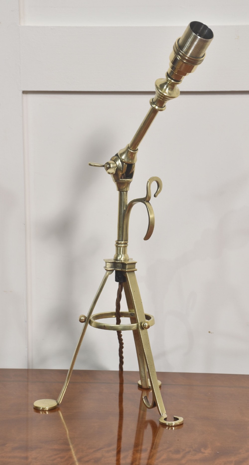 A pair of antique brass adjustable lamps featuring tripod bases with pad feet, central articulated joints with wing nuts, and tilting bulb holders. View XIII