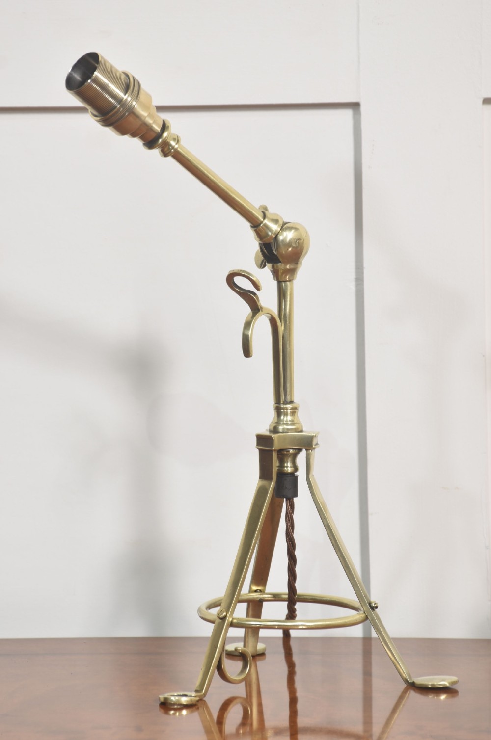A pair of antique brass adjustable lamps featuring tripod bases with pad feet, central articulated joints with wing nuts, and tilting bulb holders. View XV