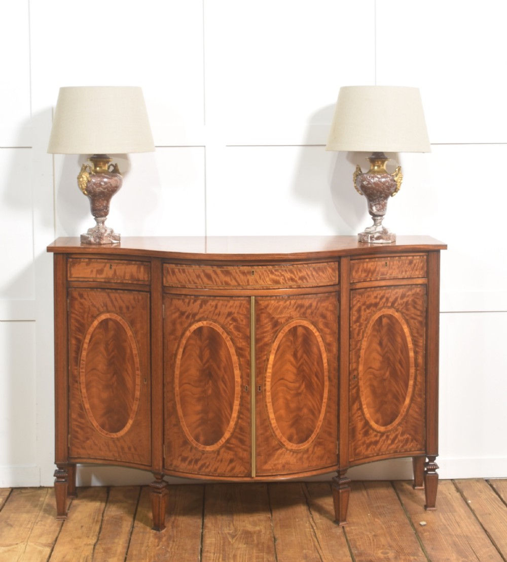 A pair of urn-shaped table lamps crafted from veined red marble with gilt brass collars and decorative side handles. View II