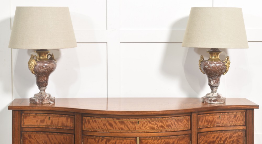 A pair of urn-shaped table lamps crafted from veined red marble with gilt brass collars and decorative side handles. View III