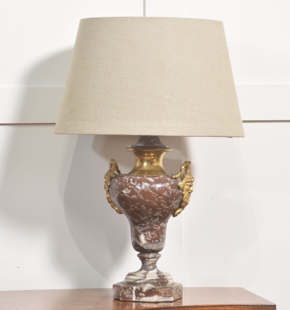 A pair of urn-shaped table lamps crafted from veined red marble with gilt brass collars and decorative side handles. View IV