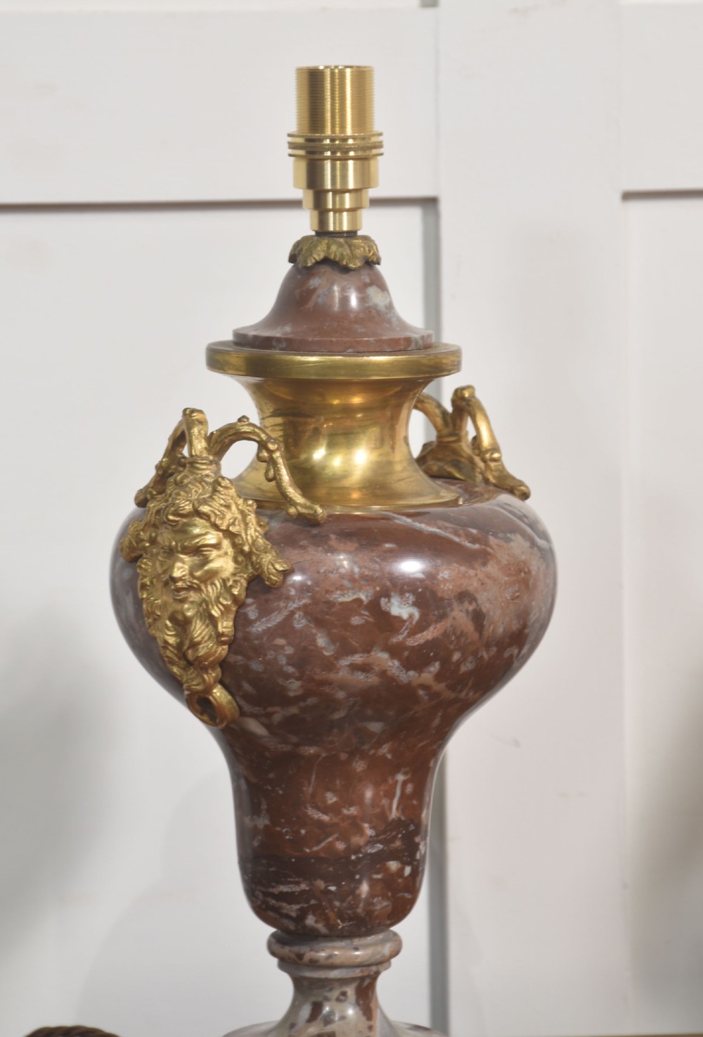 A pair of urn-shaped table lamps crafted from veined red marble with gilt brass collars and decorative side handles. View VI