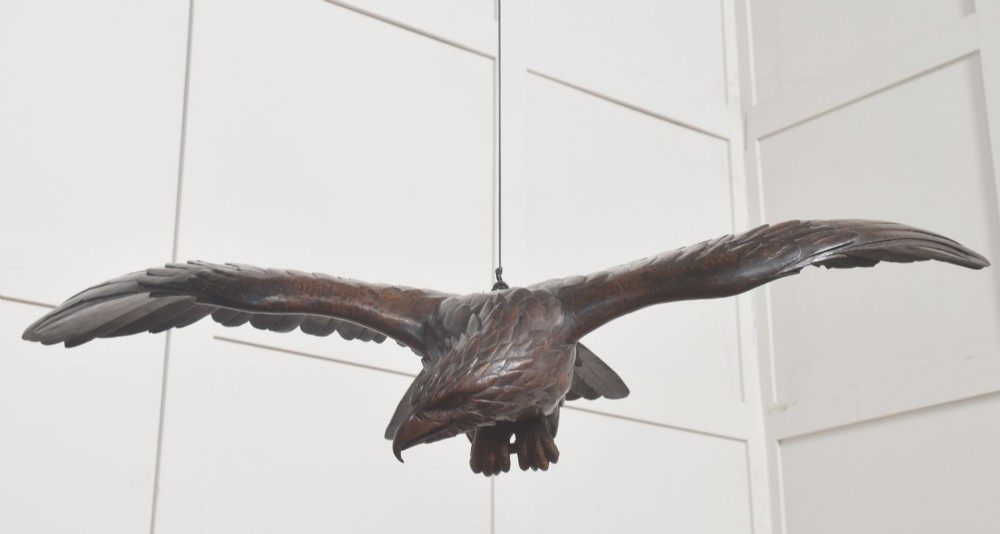 A dark wood eagle sculpture hand-carved in mid-flight with outstretched wings and carved feather detailing. View VI