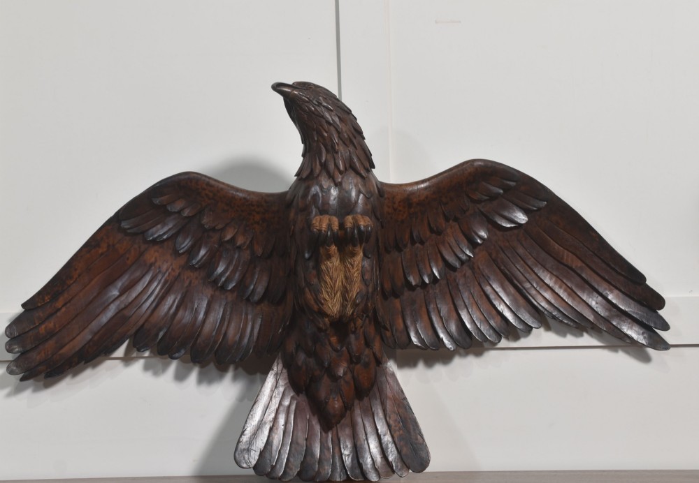 A dark wood eagle sculpture hand-carved in mid-flight with outstretched wings and carved feather detailing. View VIII