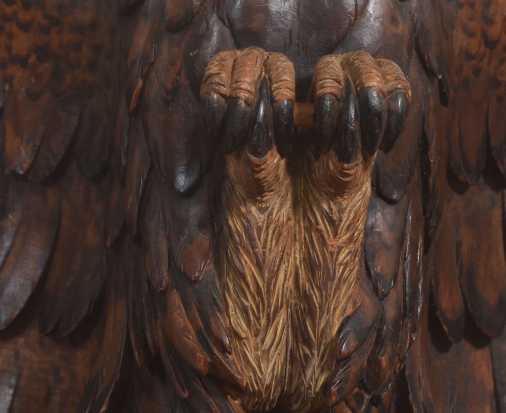 A dark wood eagle sculpture hand-carved in mid-flight with outstretched wings and carved feather detailing. View IX