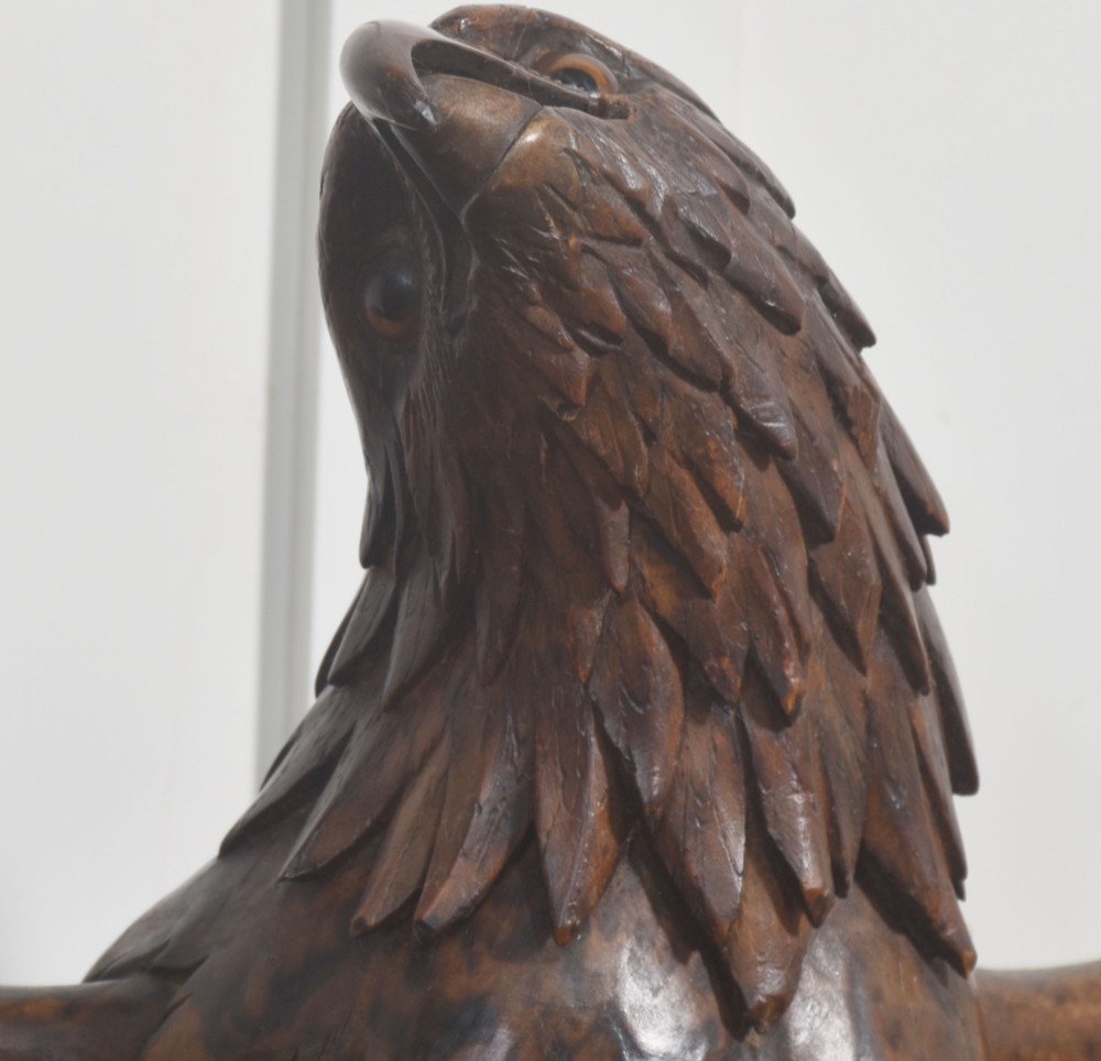 A dark wood eagle sculpture hand-carved in mid-flight with outstretched wings and carved feather detailing. View XI