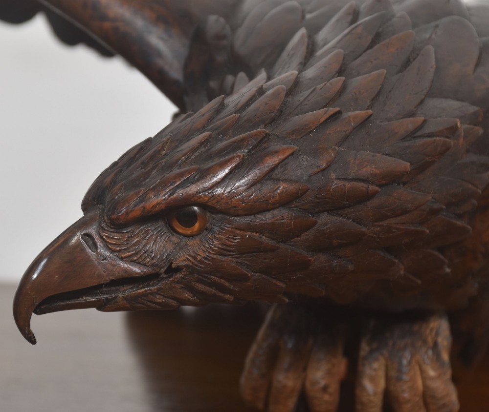 A dark wood eagle sculpture hand-carved in mid-flight with outstretched wings and carved feather detailing. View XIII