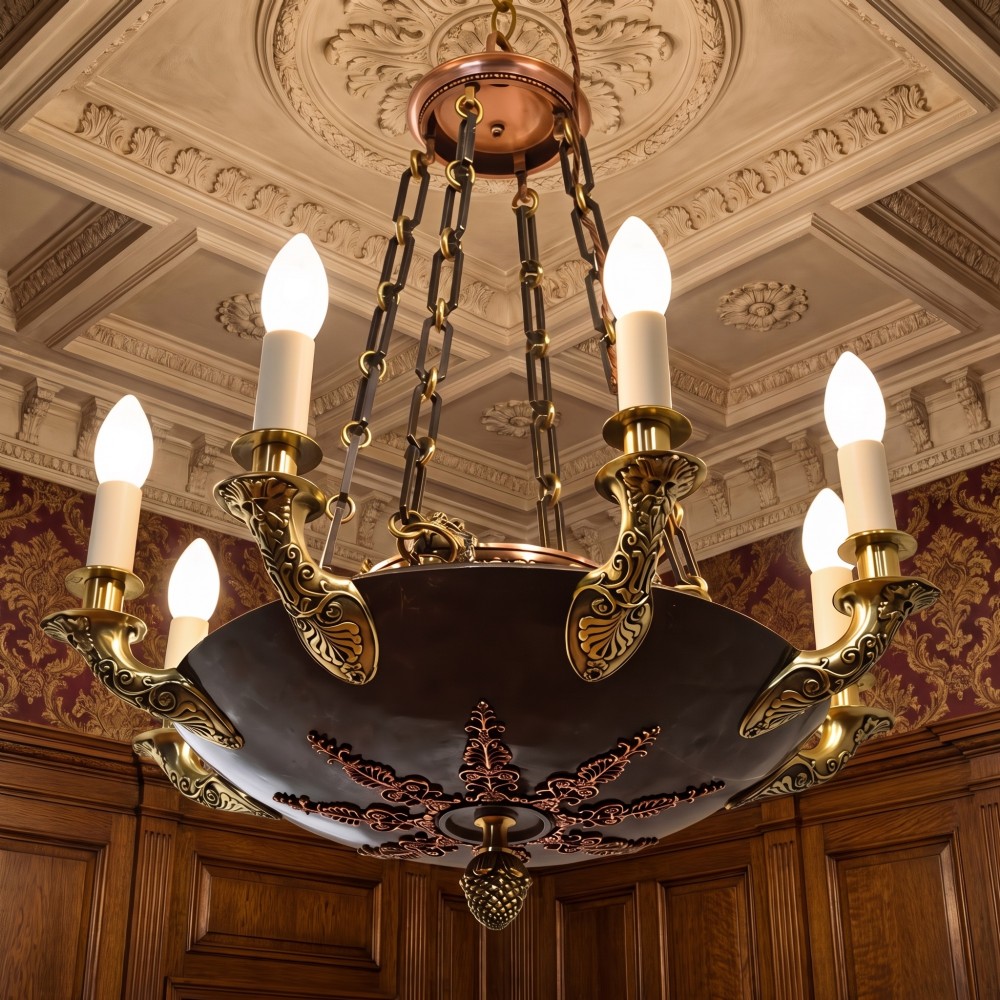 An Empire Revival brass and copper eight-light chandelier featuring a central dish supported by link chains and decorated with cast brass mounts and candle-style lights. View II