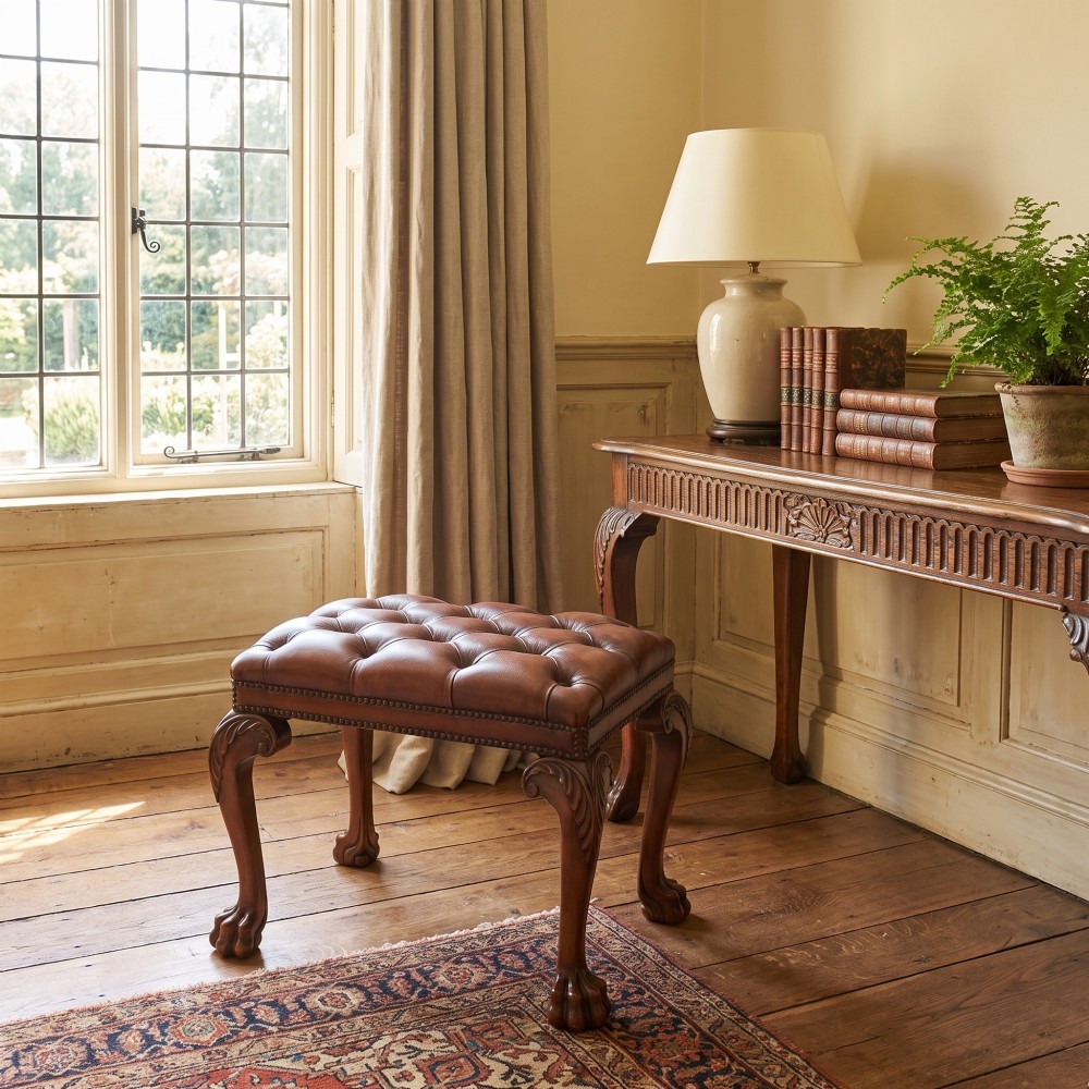 A deep-buttoned brown leather stool featuring brass stud detailing and carved mahogany cabriole legs ending in ball-and-claw feet. View II