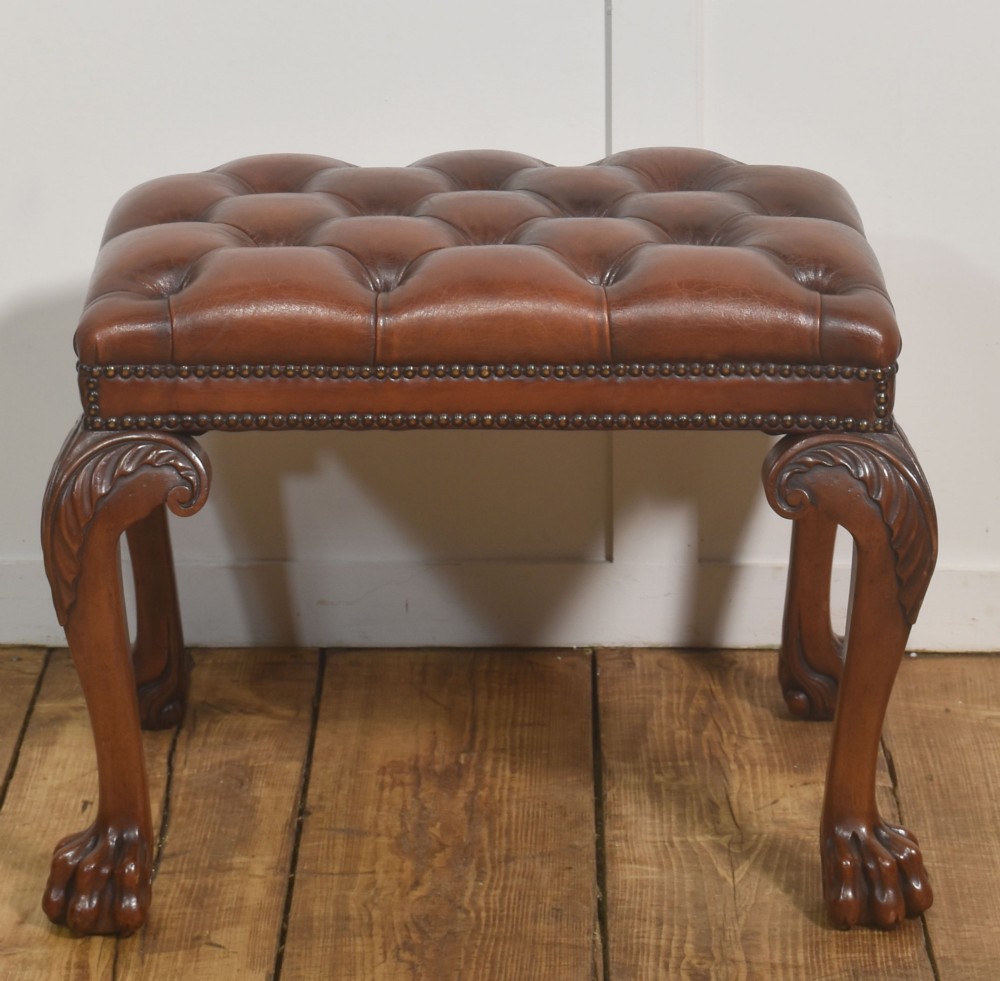 A deep-buttoned brown leather stool featuring brass stud detailing and carved mahogany cabriole legs ending in ball-and-claw feet. View VI
