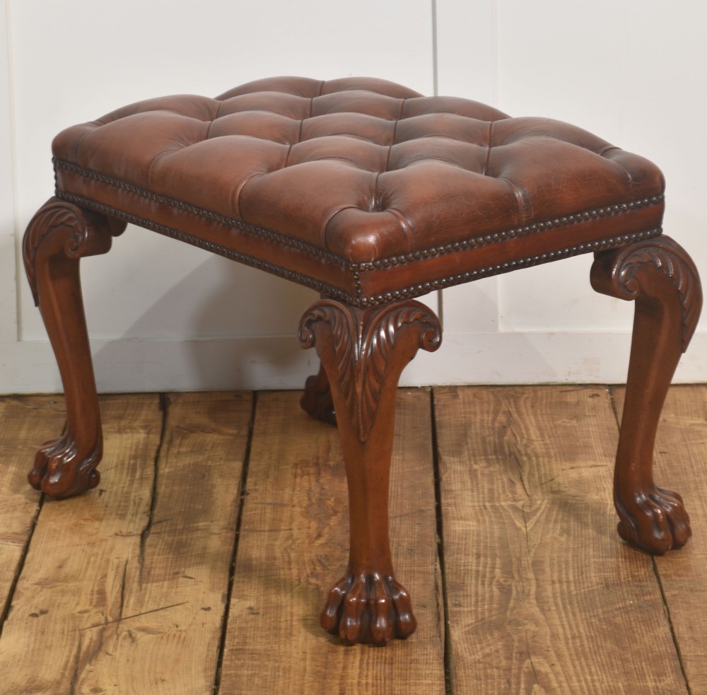 A deep-buttoned brown leather stool featuring brass stud detailing and carved mahogany cabriole legs ending in ball-and-claw feet. View VII