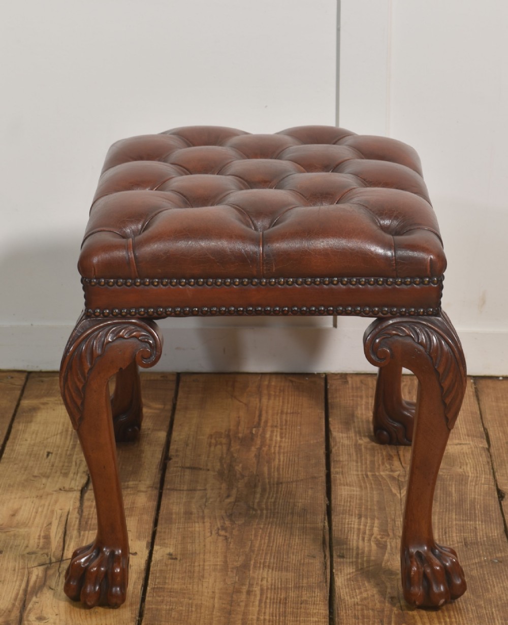 A deep-buttoned brown leather stool featuring brass stud detailing and carved mahogany cabriole legs ending in ball-and-claw feet. View VIII