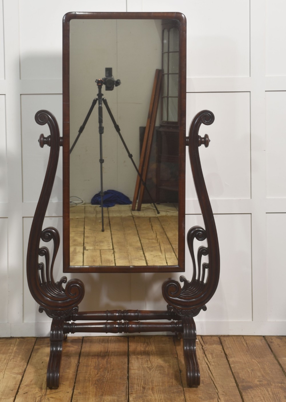 A William IV mahogany cheval mirror featuring carved scroll upright supports, a tilting full-length rectangular glass frame, and a stretcher base with swept feet. View VI