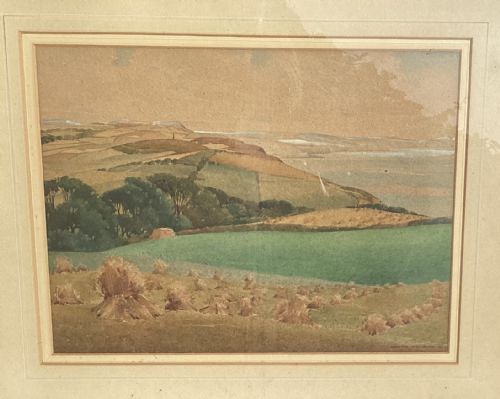 fig 1. A framed 1943 watercolour painting by Clarence Woodburn depicting rolling green and ochre hills overlooking Cardigan Bay.