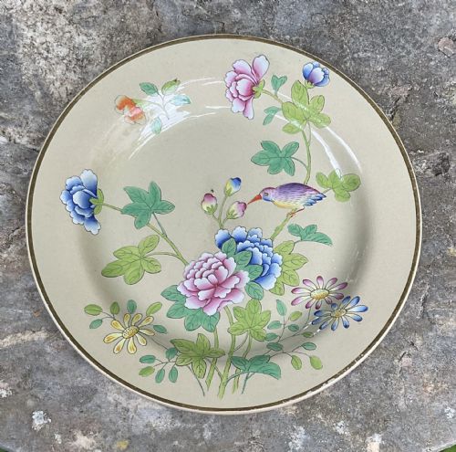 fig 1. An antique Wedgwood drabware dessert service featuring several round plates and an elongated serving dish decorated with hand-painted botanical flowers and birds.