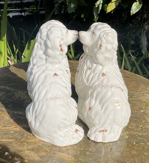 fig 1. A pair of Victorian white glazed earthenware Staffordshire spaniel dog figurines with gilded accents and hand-painted facial features.