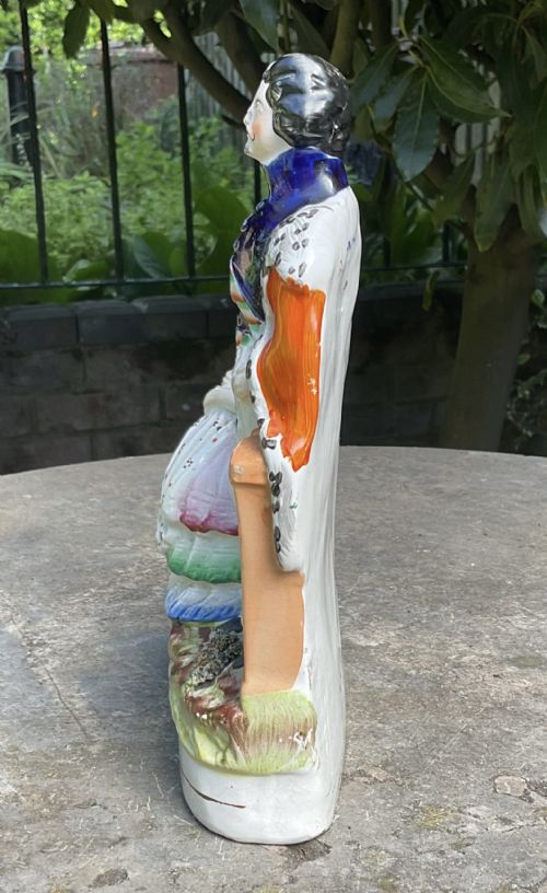fig 1. A Victorian Staffordshire earthenware flatback figure depicting Emperor Napoleon III standing beside Empress Eugenie holding an infant, finished in polychrome glazes.