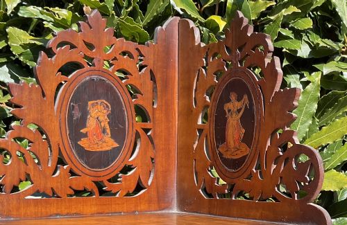 fig 1. A Victorian three-tiered olive wood corner shelf with pierced fretwork edges and oval inlaid marquetry panels depicting Italian figures.
