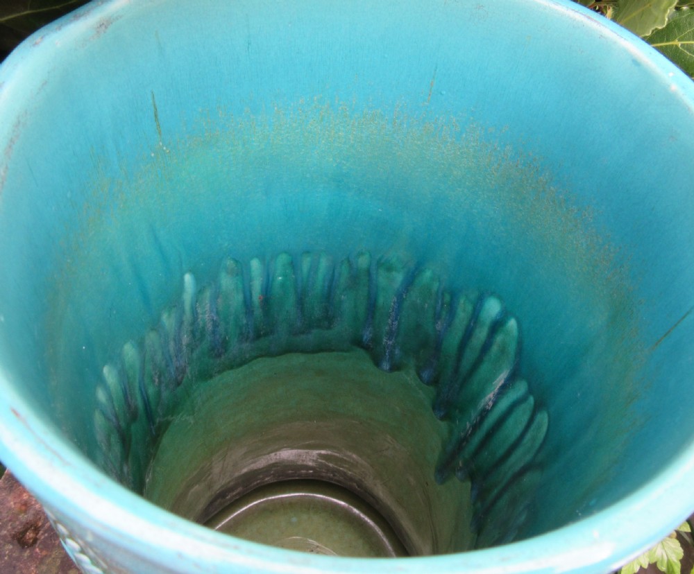 A cylindrical turquoise glazed earthenware umbrella stand decorated with raised relief carvings of fish, flora, and a bird. View IV