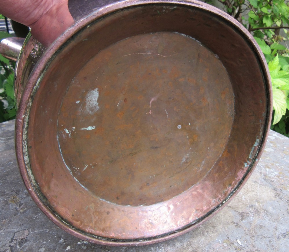 A polished Georgian copper tavern jug featuring a bulbous body, cylindrical neck, pouring spout, flared base, and a thick curved handle. View IV