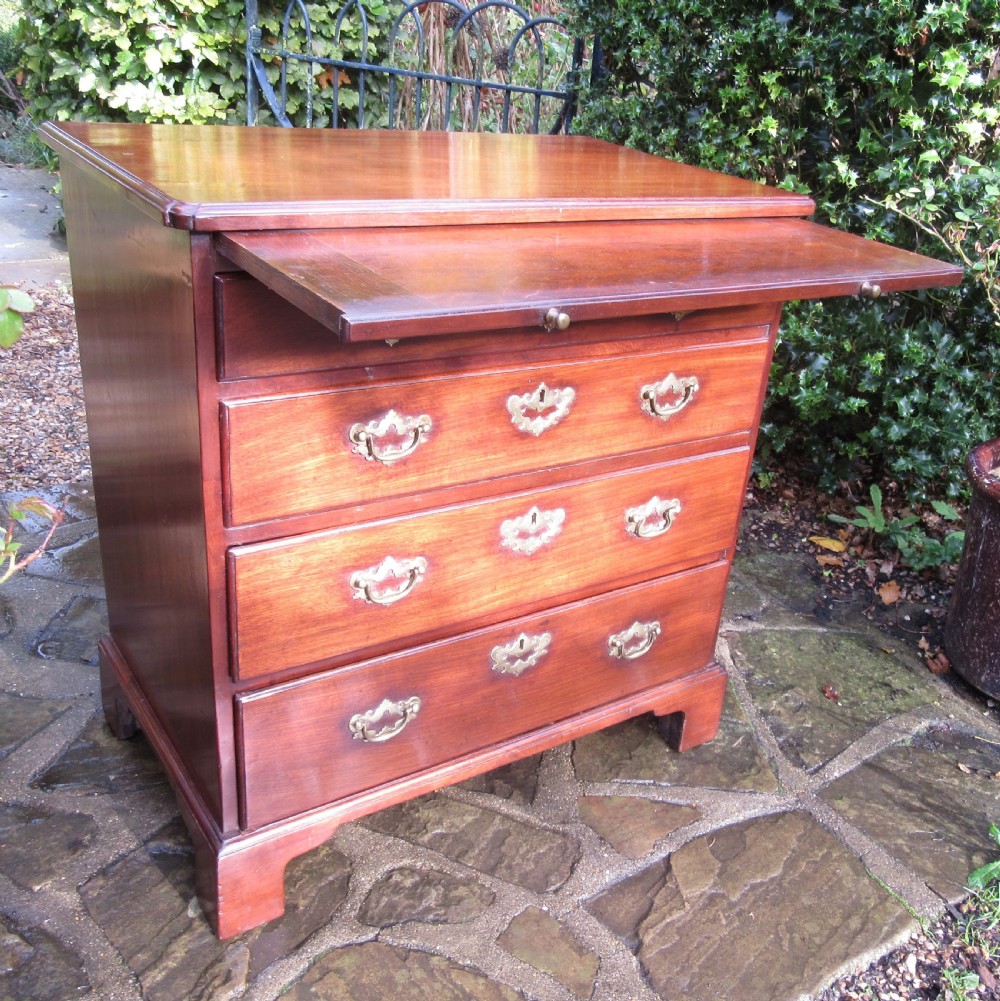 An 18th-century Georgian mahogany chest of drawers featuring four graduated drawers with brass handles, a brushing slide, and bracket feet. View II