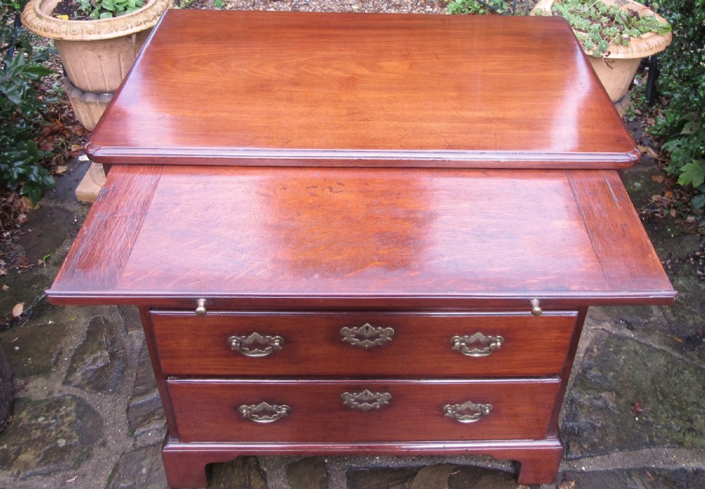 An 18th-century Georgian mahogany chest of drawers featuring four graduated drawers with brass handles, a brushing slide, and bracket feet. View IX