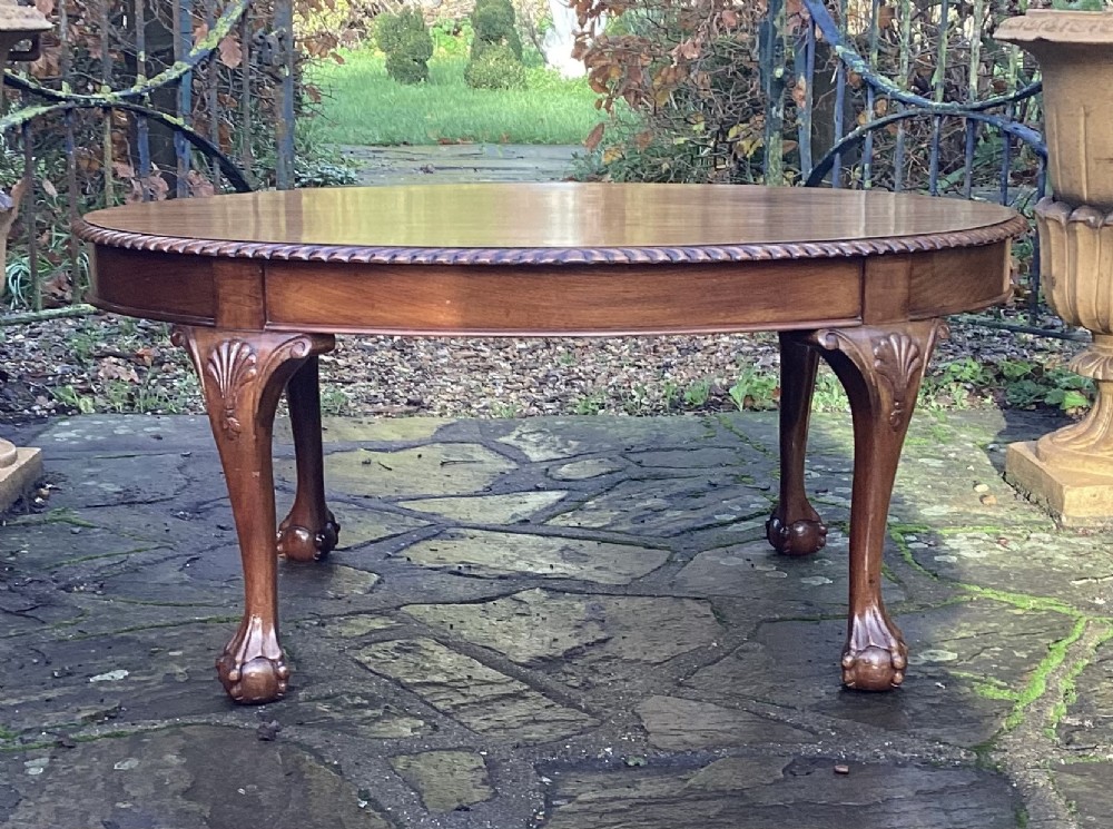 GOOD MAHOGANY BALL AND CLAW OVAL COFFEE TABLE