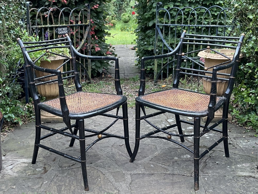 A pair of Regency ebonised armchairs featuring faux bamboo turned wood frames, lattice backrests, gilt highlights, and hand-woven cane seats. View III